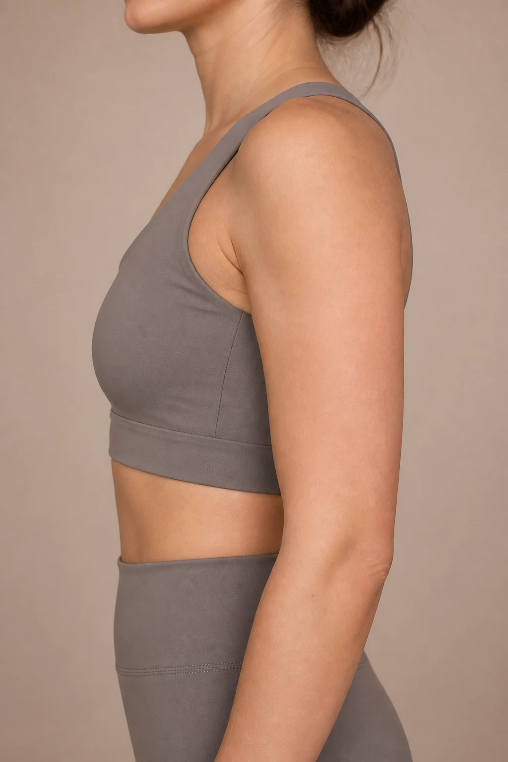 Adult woman in side view with a clear outer-arm tattoo placement area