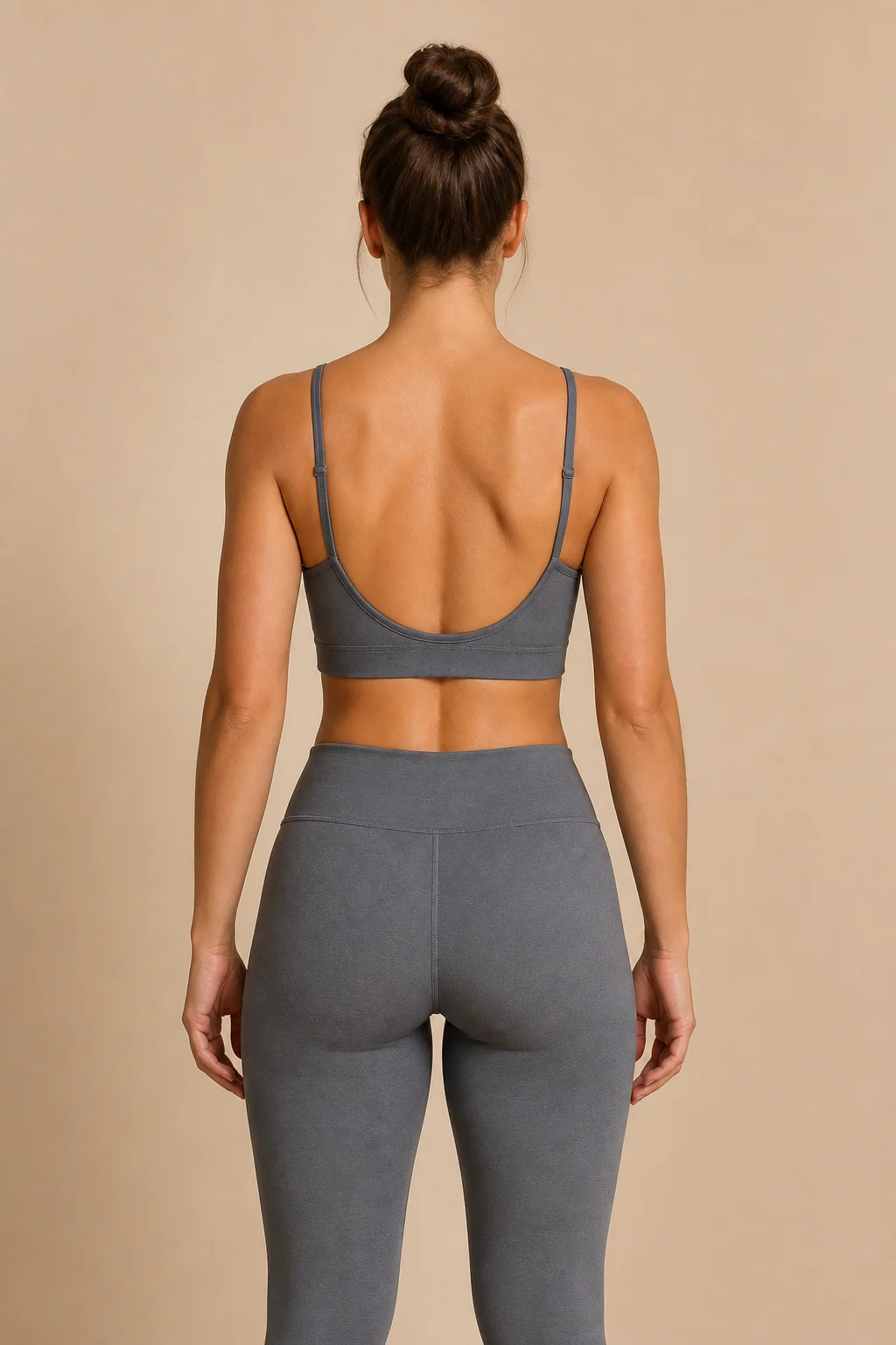Adult woman viewed from behind with bare upper-back skin visible for tattoo placement